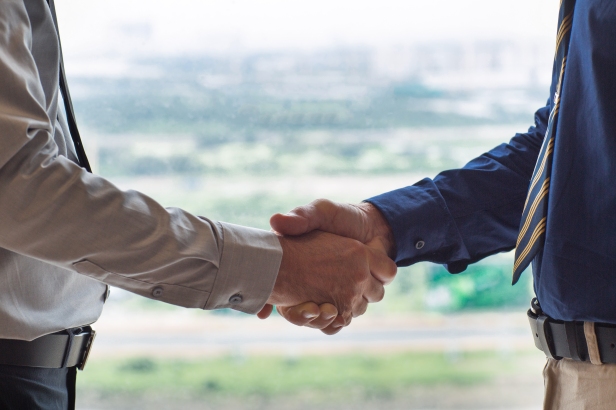 Closeup of Two Businessmen Shaking Hands